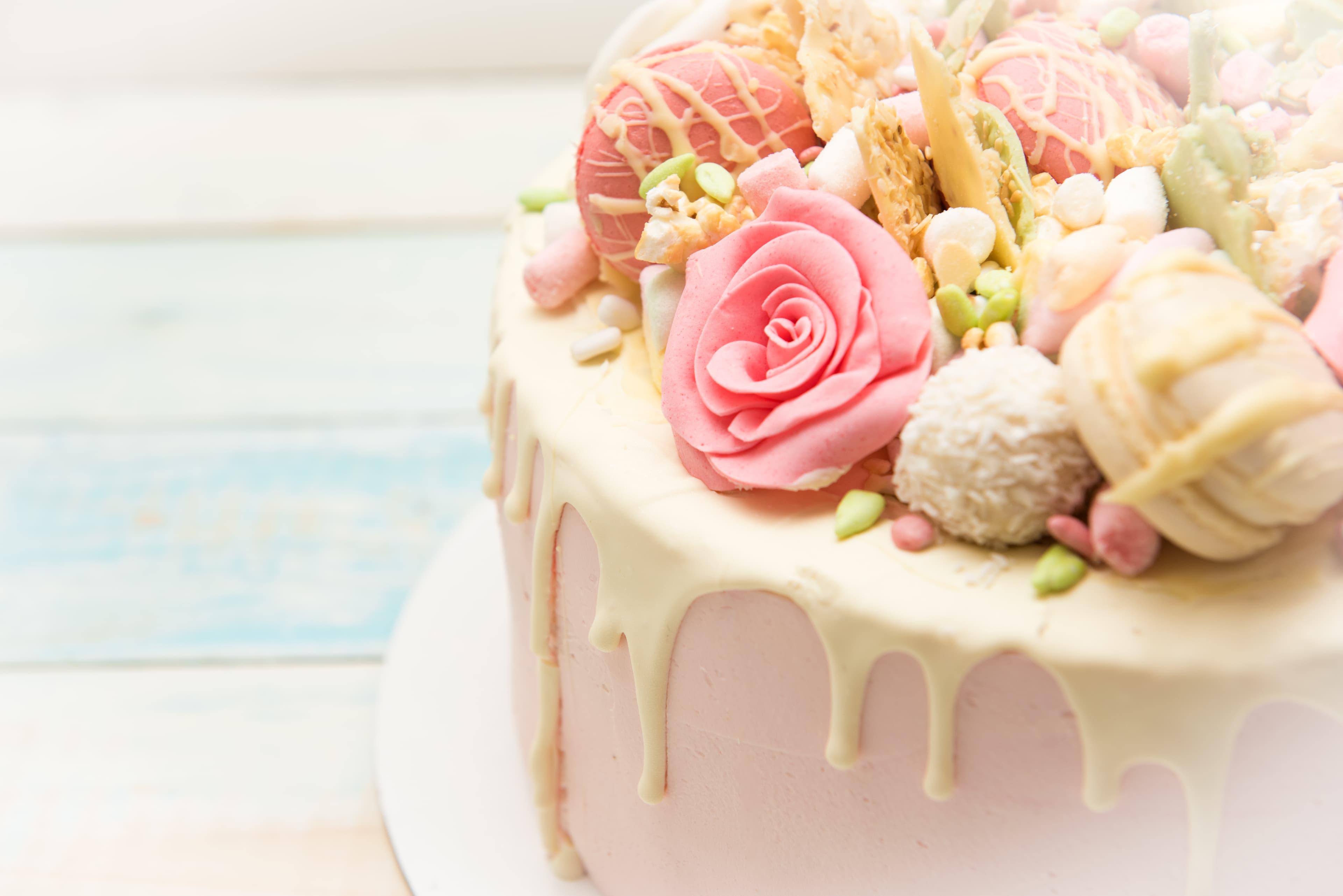 Pink and off-white drip flower cake